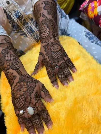 A full-arm design in a modern floral style, with checkered patterns and paisleys adding a traditional touch.