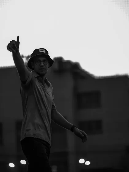 A thumbs-up in silhouette. A simple gesture of approval and encouragement from coach to player.