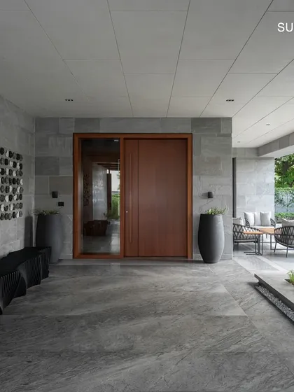 The entrance of Residence 338 features a striking wall art installation and a warm wooden door, setting a tone of artistic sophistication from the moment you arrive.