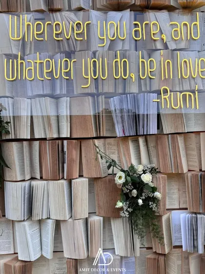 A close-up of the Rumi quote on the book wall, a deeply romantic and personal touch for the couple.