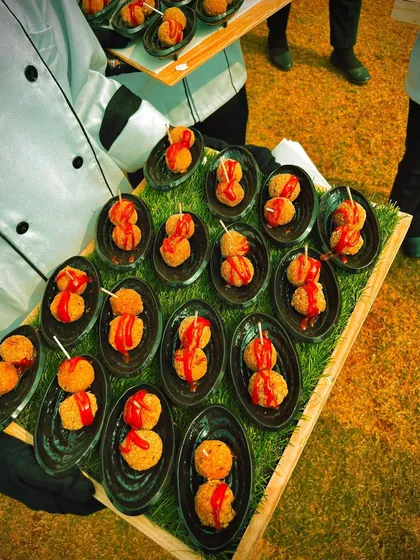 A tray of classic cheese balls, perfectly fried and ready to be served as a pass around starter. Even simple dishes are prepared with care and presented beautifully.