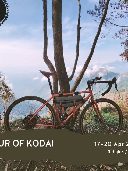 A well-deserved break with a view. This gravel bike is parked against a backdrop of the stunning Kodaikanal hills, showcasing the kind of terrain and scenery you can expect on our 'Tour of Kodai'.