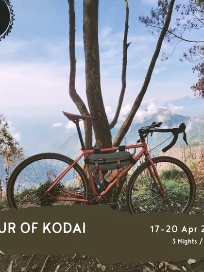 A well-deserved break with a view. This gravel bike is parked against a backdrop of the stunning Kodaikanal hills, showcasing the kind of terrain and scenery you can expect on our 'Tour of Kodai'.