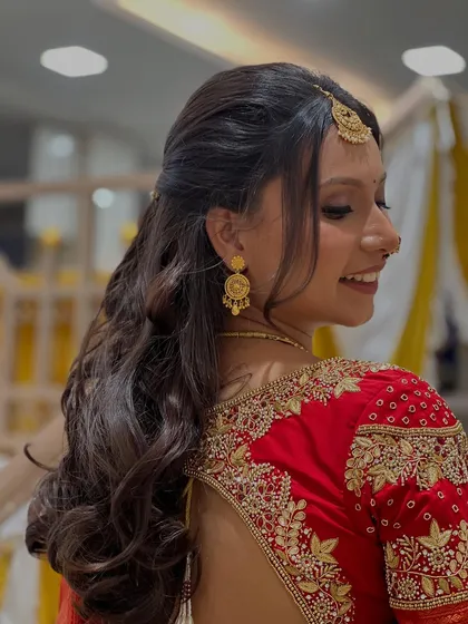 A closer look at the intricate embroidery on the blouse and the beautiful half-up, half-down hairstyle.