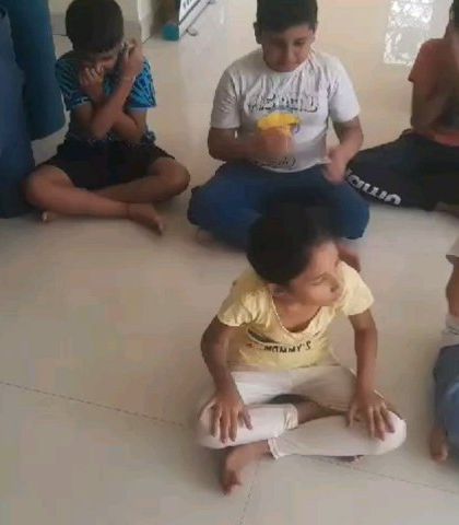 A moment of calm and focus as children practice a breathing exercise. Sessions like these teach simple Pranayama techniques that help kids manage their energy, improve concentration, and find stillness.