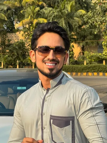 A happy client in a grey kurta with modern pocket details. His smile is a testament to the confidence a well-fitted outfit can bring.