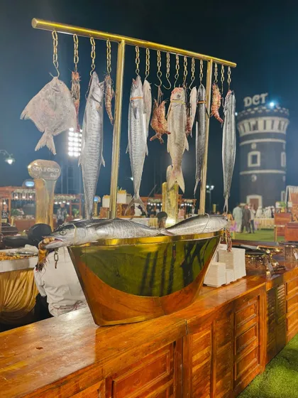 I pride myself on sourcing the freshest ingredients. This display showcases the quality of our seafood, featuring whole pomfret and surmai, ready to be cooked to perfection at our live counters.