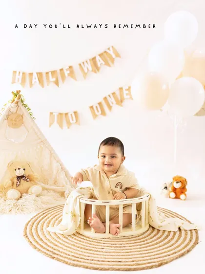 A day you'll always remember. A classic first birthday setup with a teepee, teddy bear, and a happy baby celebrating turning one.