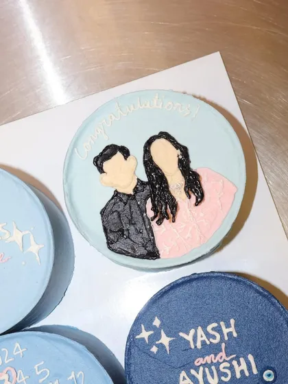 This bento cake from an engagement set features a custom hand-piped portrait of the happy couple. It's a sweet way to capture a special memory.