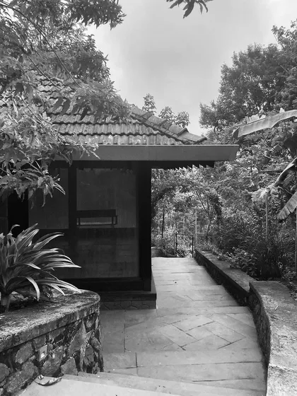 The stone pathway leading to the yoga pavilion at PLENTI House, which is tucked away in a quiet corner of the property.