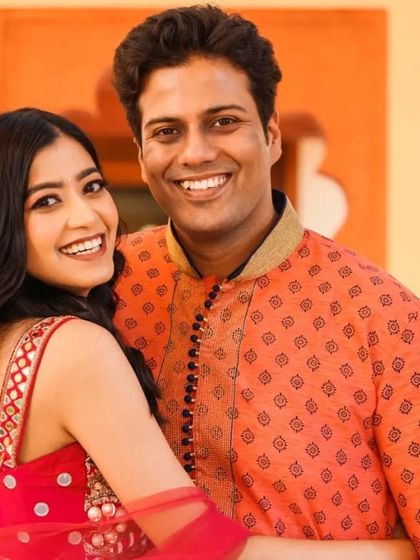 Bright smiles and happy hearts. This close-up portrait captures the infectious joy of the couple, a simple and beautiful memory from their pre-wedding celebrations.