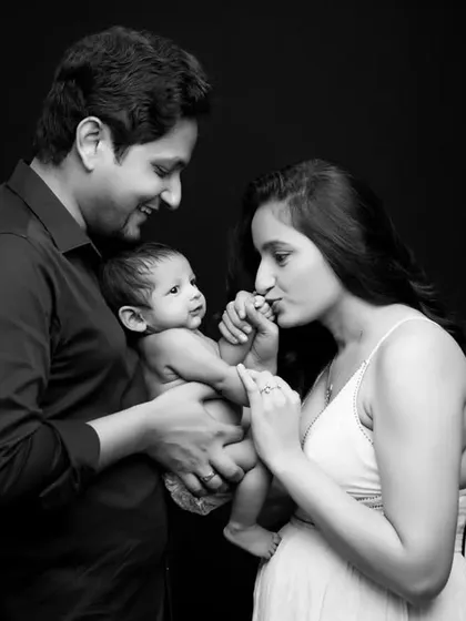 A beautiful composition of new parents admiring their baby in our studio. This black and white family portrait is an example of how we capture the story of a new family beginning.