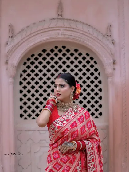 A portrait taken in front of a latticed window, adding architectural interest to the shot.