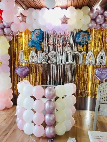 A beautiful balloon arch decoration in pastel pink, yellow, and chrome gold. This versatile setup can be used for various themes like princess or unicorn parties.