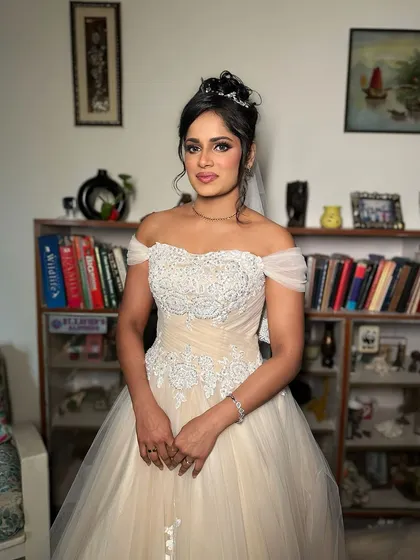 The full view of this angelic white wedding look. The makeup is soft and defined, enhancing her natural beauty for her special day.
