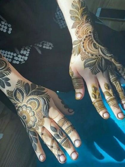 Two hands with different Arabic-inspired floral designs, showing how patterns can be mixed and matched.