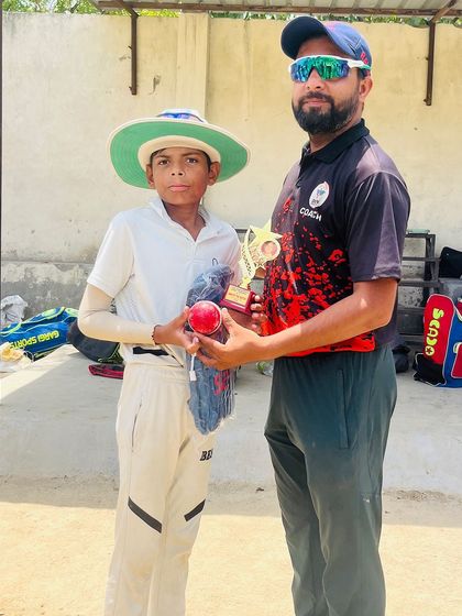 Ayush with his Man of the Match trophy and the match ball after taking 5 wickets.