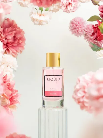 To capture the essence of a perfume named 'Paris', I created a frame of soft pink flowers. This styling choice immediately evokes feelings of romance, spring, and floral fragrance notes.