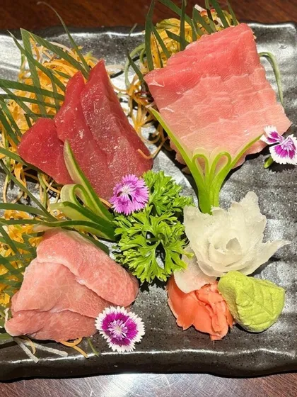 A closer look at our premium tuna sashimi, showcasing the distinct textures and colors of Otoro, Chutoro, and Akami. Each piece is a testament to the quality of fish imported from Japan.