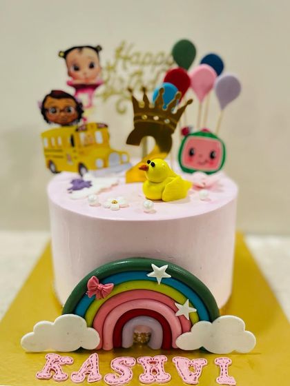 A sweet and simple Cocomelon cake with a rainbow and ducky. This pink cake is perfect for a smaller, more intimate first birthday celebration.