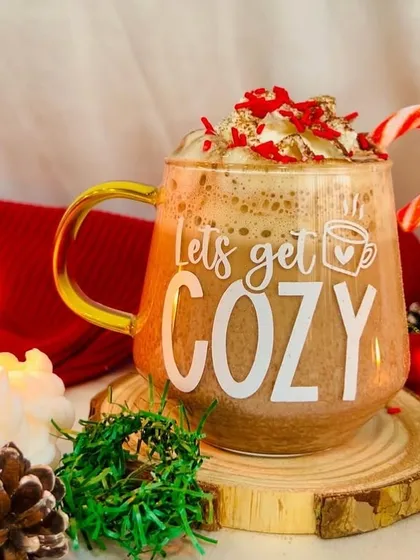 'Let's get cozy' with this beautiful glass mug, perfect for hot chocolate on a chilly evening.