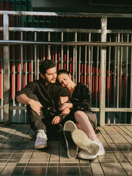 A quiet, reflective moment shared by a couple on a city bridge. This photo captures the feeling of finding peace and connection amidst the hustle and bustle of Mumbai.