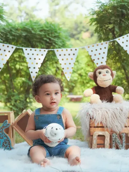 An outdoor milestone session with a classic setup. The natural light and greenery create a beautiful, fresh look for your baby's portraits.