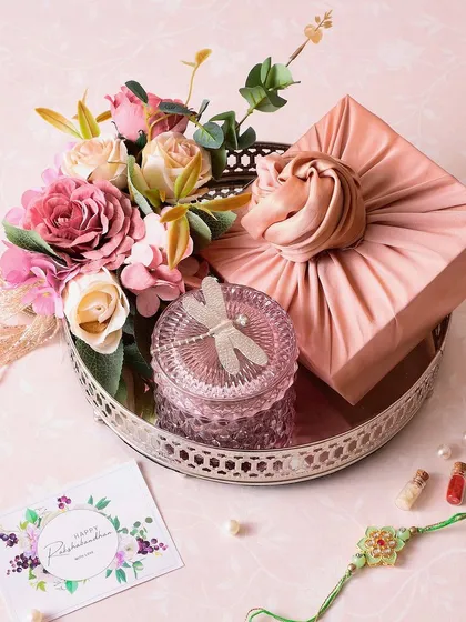 The Dragonfly Dreams hamper is a beautiful arrangement on a silver tray, featuring a box of fudge brownies and a dragonfly jar with cookies.