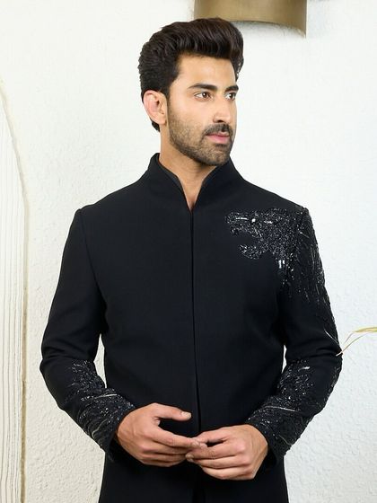 A full-length view of the black kurta with the signature cheetah embroidery on the shoulder and sleeve. A majestic piece that exudes understated opulence.
