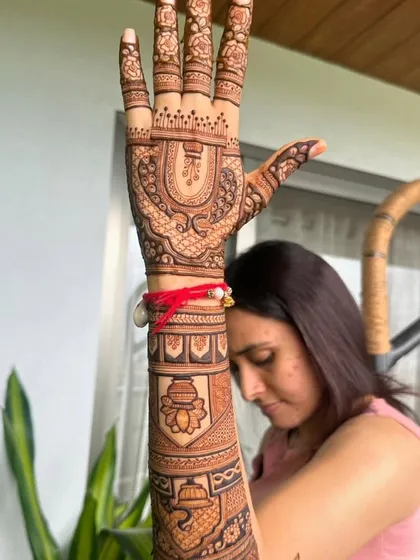 This design for a festival features a kalash (ceremonial pot) on the arm, a symbol of prosperity.