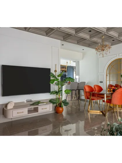A complete view of the living and dining areas, showing how we create distinct zones within an open-plan space. The consistent flooring and wall treatment unify the areas, while furniture and lighting define their purpose.