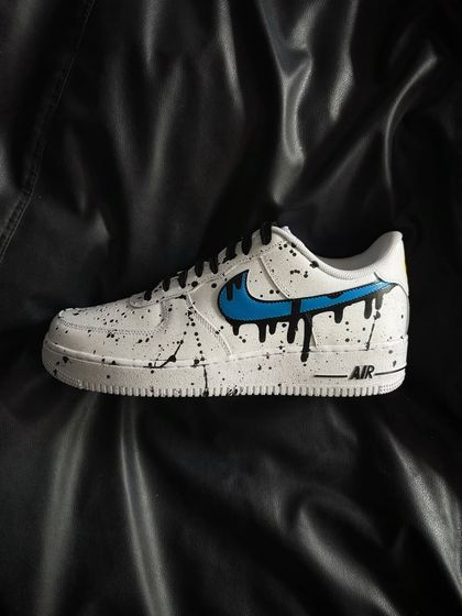A side profile of the blue drip custom sneaker.