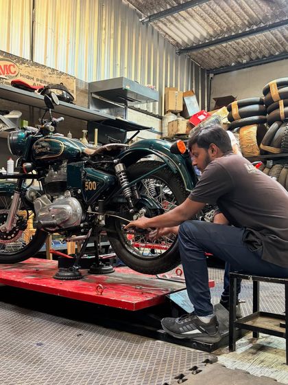 A 1998 Bullet 500 up on the lift, getting a thorough check-up and service to keep it running smoothly.