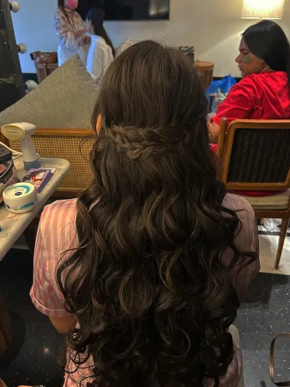 The same hairstyle before adding accessories, showing the beautiful simplicity of the waterfall braid and curls.