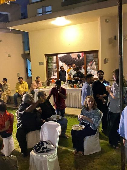A wide shot of the lively dinner party.