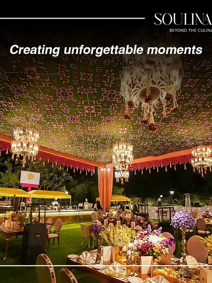 A grand outdoor celebration with a stunning tent decorated with traditional patterns and chandeliers. We help create unforgettable moments.