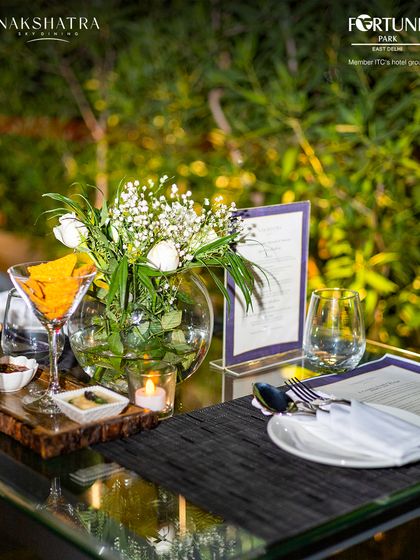 An intimate table setting at Nakshatra, complete with fresh flowers and candlelight, perfect for a romantic evening.