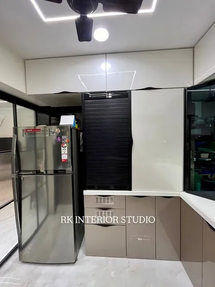 A closer look at the appliance garage with a roller shutter, a great way to keep countertops clutter-free. The handleless drawers and cabinets add to the sleek, modern aesthetic.