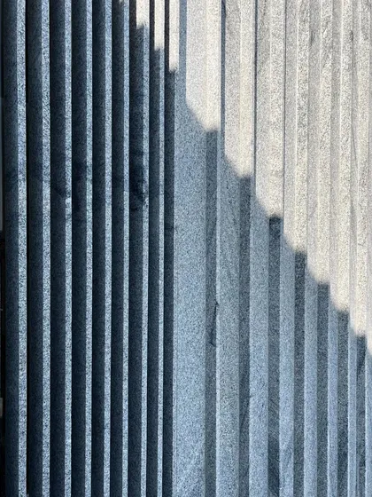 A close-up of the light and shadow on a textured stone wall. This kind of detail is what gives a building its character and visual interest.