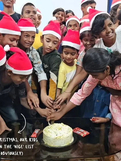 This Christmas, our kids are on the 'nice' list. A group of children gathers to cut a cake, a sweet moment of community and celebration.