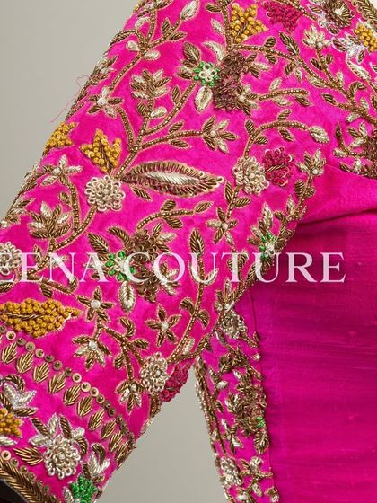 This bright pink raw silk blouse is a showcase of exquisite craftsmanship. The sleeves and back are covered in dense, multi-colored floral handwork, and I added beautiful custom tassels with bead detailing to complete the look.