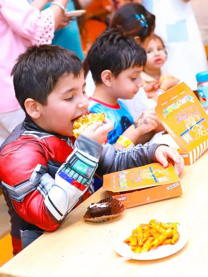 A superhero enjoying his pizza and pasta. Our meal boxes are a convenient and popular option for parties.
