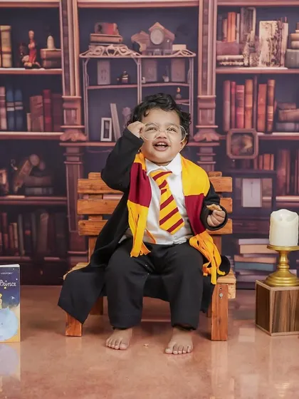 A joyful, magical moment captured in the library. His happy expression shows just how much fun these fantasy shoots can be.