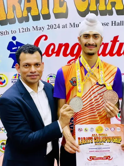 Posing with my coach and my medals from the All India Karate Championship. Our success is a shared one, built on a foundation of trust and hard work.
