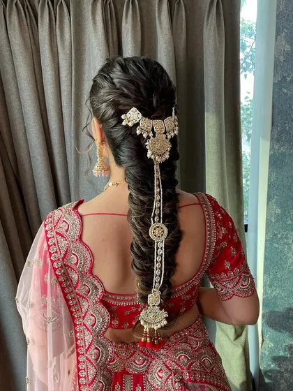 Another angle of this textured bridal braid. The accessory adds so much detail and elegance, making it a true statement hairstyle.