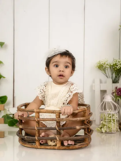 A full view of the rustic basket pose. This is a classic and safe way to photograph a baby who is confidently sitting up.
