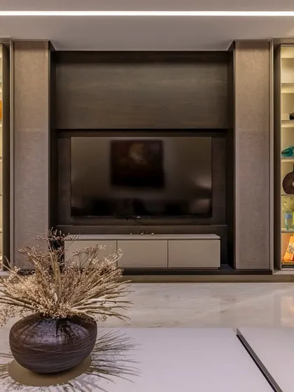 This custom media unit features backlit display shelves, providing the perfect showcase for art and collectibles. The design balances aesthetics with storage, keeping the living area organized and stylish.