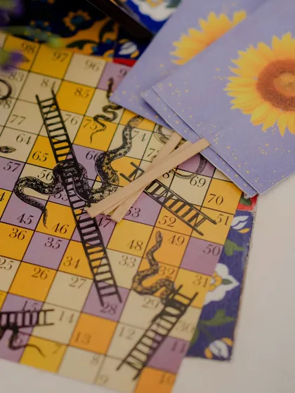We even customized the games. This traditional snakes and ladders board was redesigned with our event's color palette and motifs, providing a fun and on-theme activity for guests.
