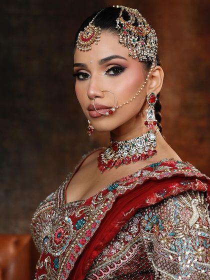 A close-up of the regal glam look, highlighting the intricate pass-style jewellery and the bold, winged eyeliner.