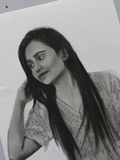 A close-up of the finished sketch, focusing on her expression and the detailed work on her hair.